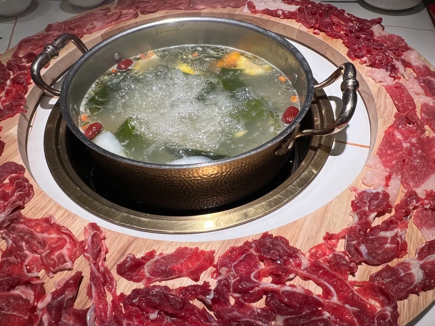 Chaoshan beef hotpot — a clear broth pot ringed by platters of fresh sliced beef