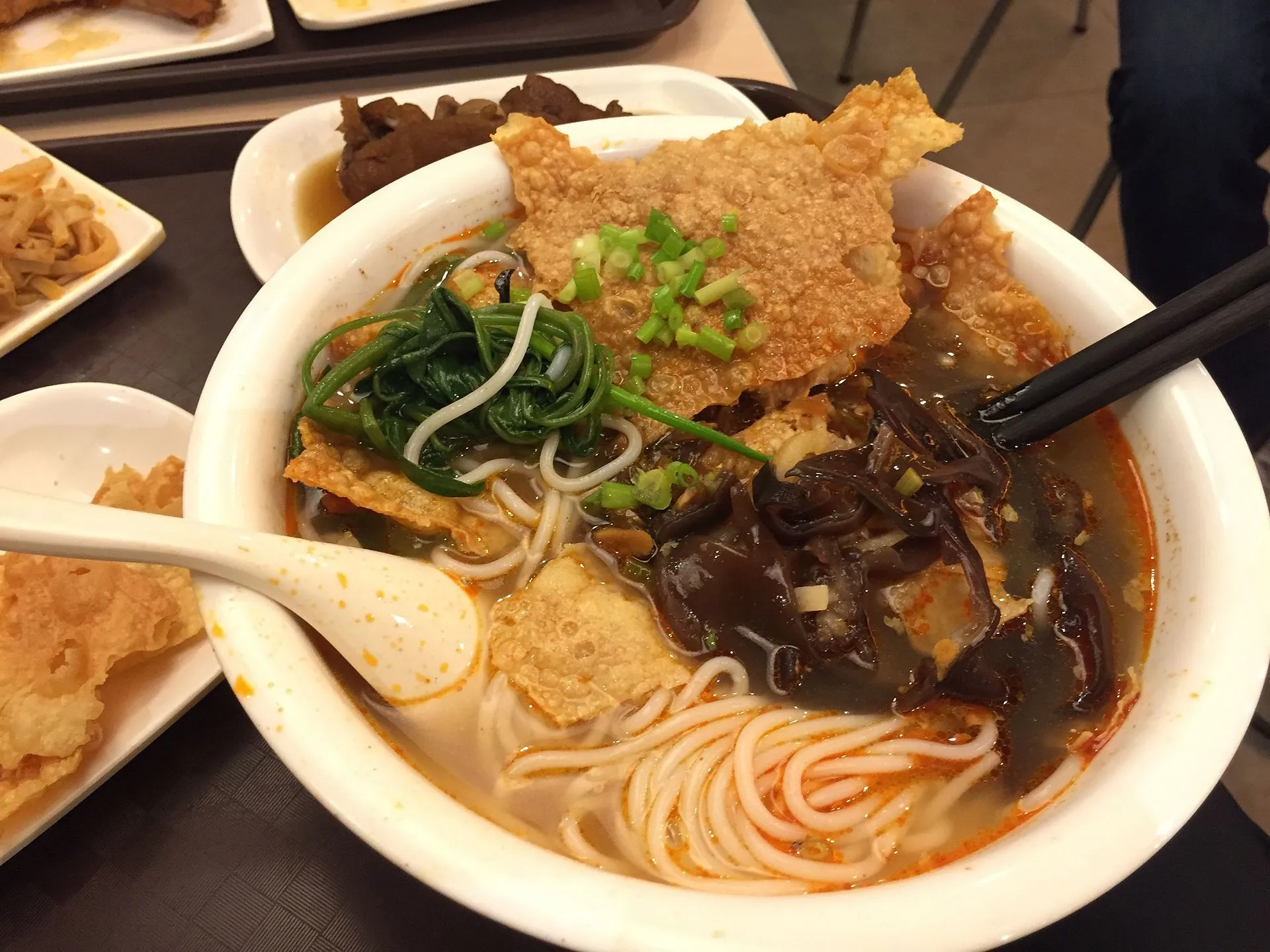 A bowl of Liuzhou luosifen — snail-broth rice noodles with toppings